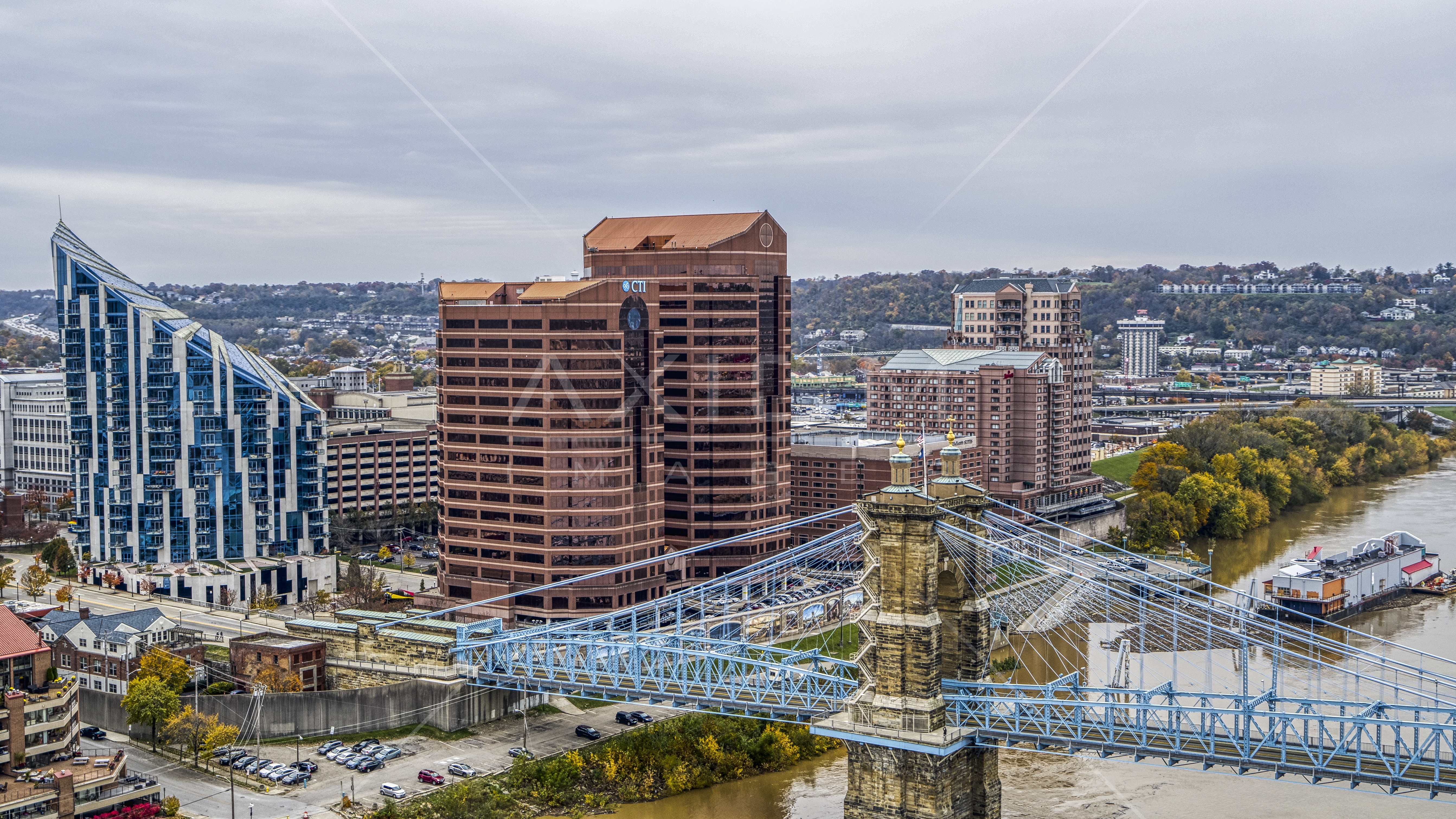 Condo complex and two office buildings beside the Roebling Bridge spanning Ohio River in