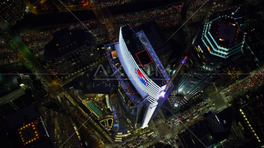 A bird's eye of Wilshire Grand Center in Downtown Los Angeles, California at night Aerial Stock Photo AX0158_122.0000260 | Axiom Images