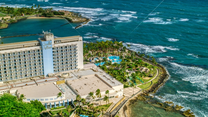 An oceanside resort hotel in the Caribbean, San Juan, Puerto Rico Aerial Stock Photo AX101_004.0000229F | Axiom Images