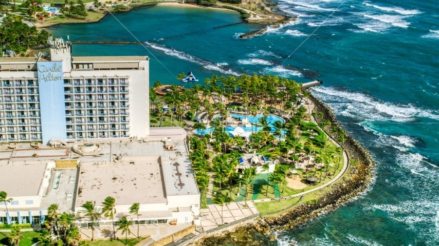Oceanside Caribbean resort hotel and pool area, San Juan, Puerto Rico Aerial Stock Photo AX101_005.0000000F | Axiom Images