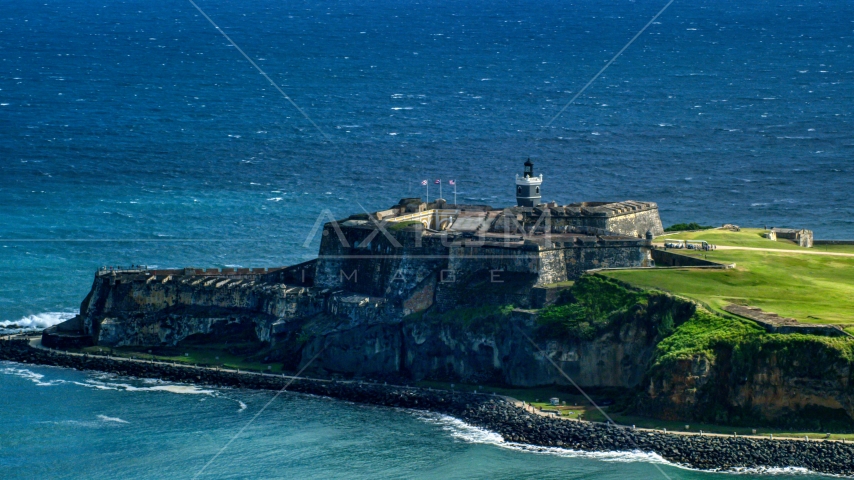 Castillo San Felipe del Morro by blue Caribbean waters, Old San Juan, Puerto Rico Aerial Stock Photo AX101_019.0000203F | Axiom Images