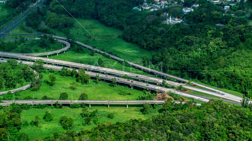 Highway cutting through rural area of grass and trees, Vega Alta, Puerto Rico Aerial Stock Photo AX101_036.0000398F | Axiom Images