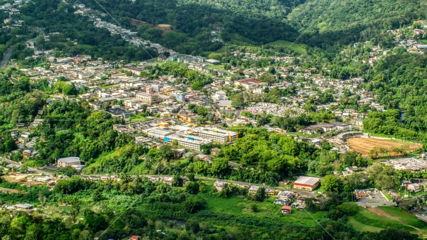 The small town of Ciales, surrounded by trees in Puerto Rico Aerial Stock Photo AX101_046.0000180F | Axiom Images