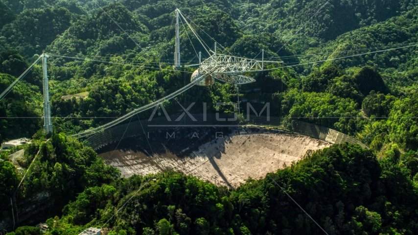 Arecibo Observatory surrounded by Karst Forest trees in Puerto Rico Aerial Stock Photo AX101_106.0000000F | Axiom Images