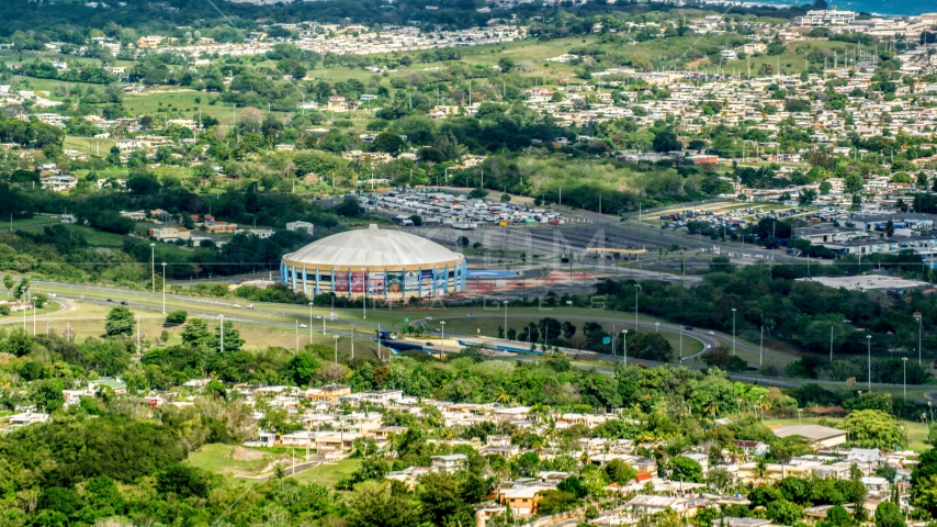 Coliseo Manuel Iguina sporting arena and homes, Arecibo, Puerto Rico Aerial Stock Photo AX101_132.0000000F | Axiom Images