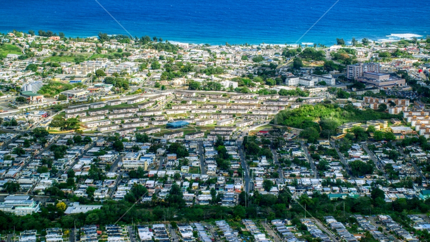 Coastal homes and apartment buildings in Arecibo, Puerto Rico Aerial Stock Photo AX101_134.0000081F | Axiom Images