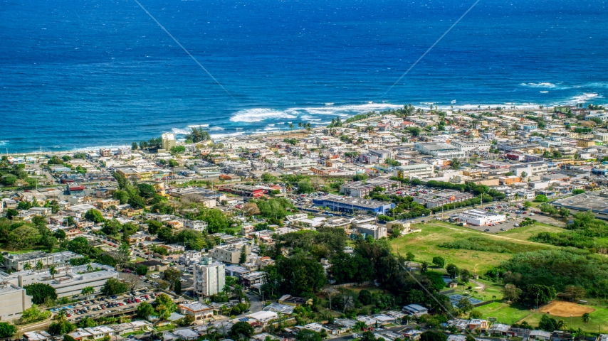 Coastal community homes and apartment buildings, Arecibo, Puerto Rico Aerial Stock Photo AX101_136.0000000F | Axiom Images