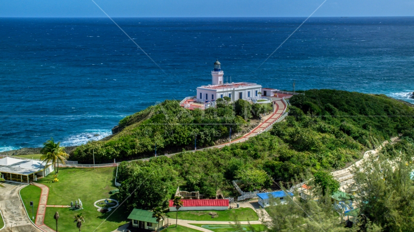 Arecibo Lighthouse with a view of the coastal waters of the Caribbean, Puerto Rico Aerial Stock Photo AX101_144.0000000F | Axiom Images