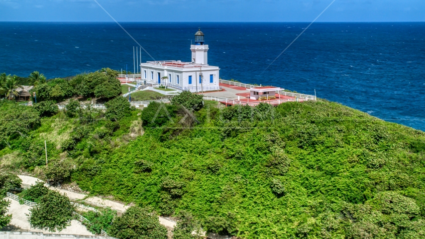 Arecibo Lighthouse and clear blue Caribbean waters, Puerto Rico Aerial Stock Photo AX101_145.0000210F | Axiom Images