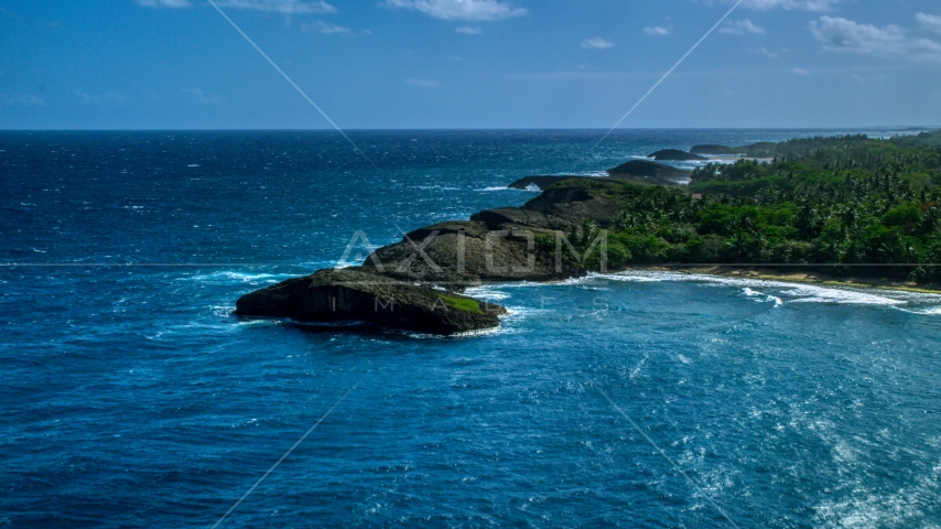Rounded rock formations along the coast in Arecibo, Puerto Rico Aerial Stock Photo AX101_160.0000000F | Axiom Images