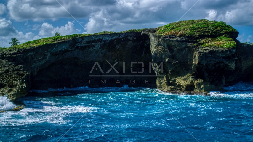 Crystal blue water and a shallow sea cave in Arecibo, Puerto Rico Aerial Stock Photo AX101_165.0000270F | Axiom Images