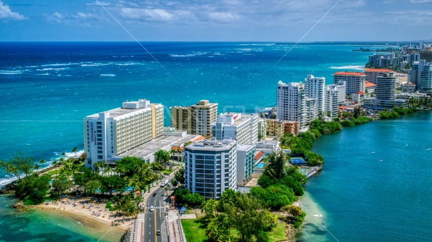 Hotels and high-rises on the coast, and crystal blue water, San Juan, Puerto Rico Aerial Stock Photo AX102_002.0000000F | Axiom Images