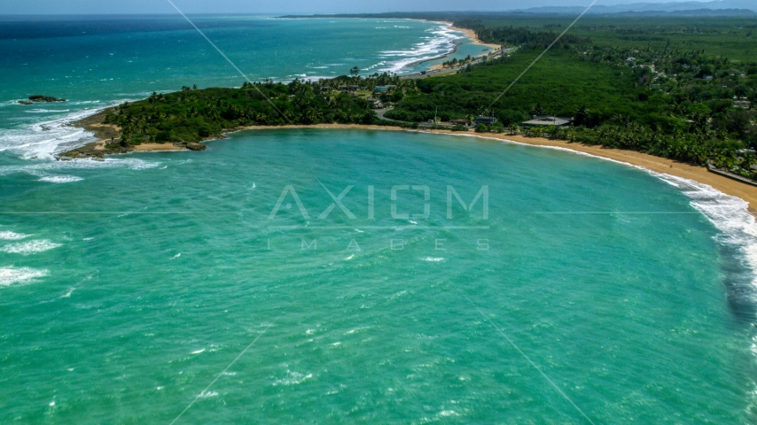 Clear turquoise waters by the beach and homes in Loiza, Puerto Rico Aerial Stock Photo AX102_016.0000216F | Axiom Images