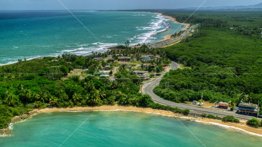 Beachfront homes beside a highway, Loiza, Puerto Rico Aerial Stock Photo AX102_017.0000095F | Axiom Images