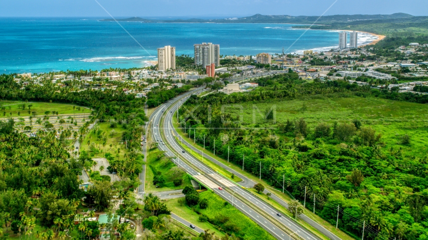 Highway 3 and a beach community with condo complexes in Luquillo, Puerto Rico Aerial Stock Photo AX102_048.0000244F | Axiom Images