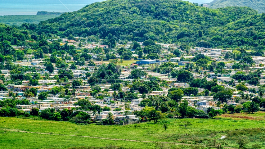 Homes beside tree covered hills, Fajardo, Puerto Rico Aerial Stock Photo AX102_055.0000000F | Axiom Images