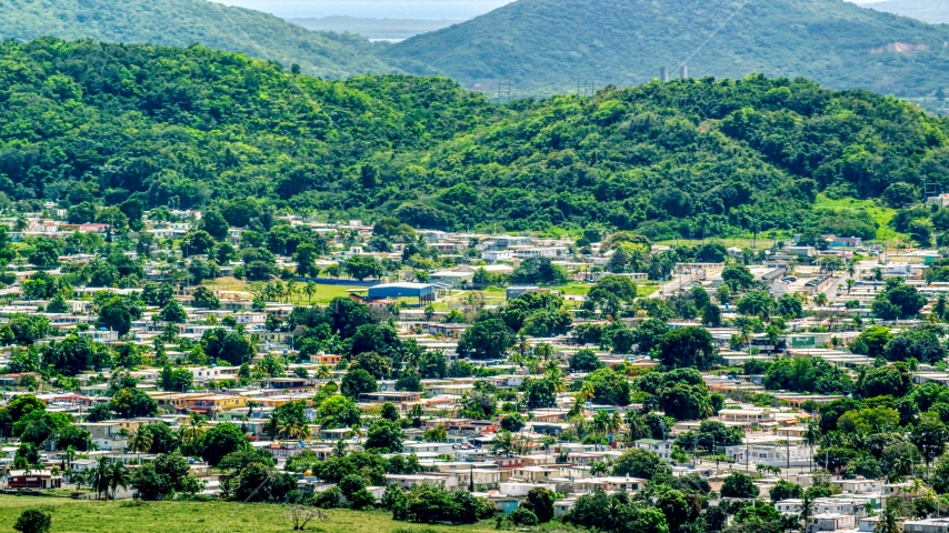 Homes at the base of tree covered hills, Fajardo, Puerto Rico Aerial Stock Photo AX102_056.0000000F | Axiom Images