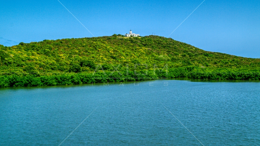 Cape San Juan Light on a hilltop in Fajardo, Puerto Rico Aerial Stock Photo AX102_061.0000230F | Axiom Images