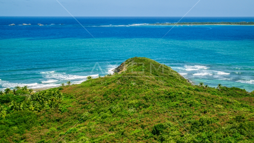 Green shore overlooking Caribbean ocean and tiny islands in Fajardo, Puerto Rico Aerial Stock Photo AX102_071.0000000F | Axiom Images