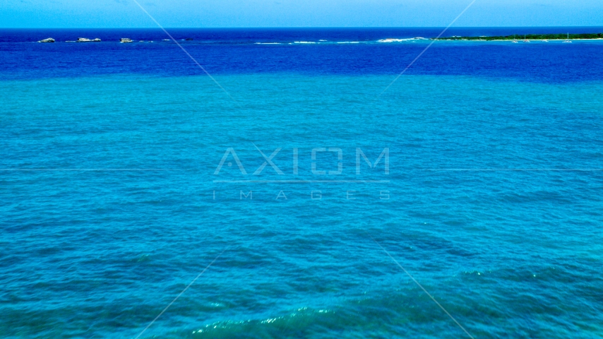 Tiny islands across blue Caribbean ocean in Fajardo, Puerto Rico Aerial Stock Photo AX102_071.0000275F | Axiom Images