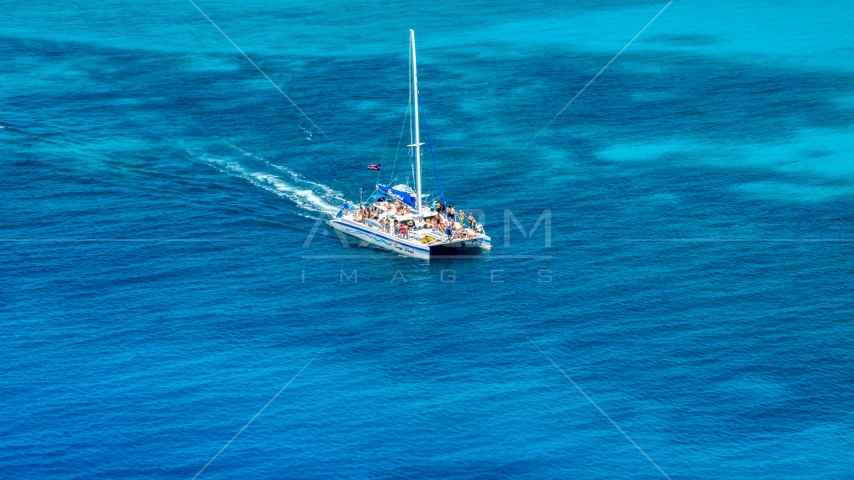 A catamaran in crystal clear blue tropical waters, Rada Fajardo, Puerto Rico Aerial Stock Photo AX102_076.0000000F | Axiom Images