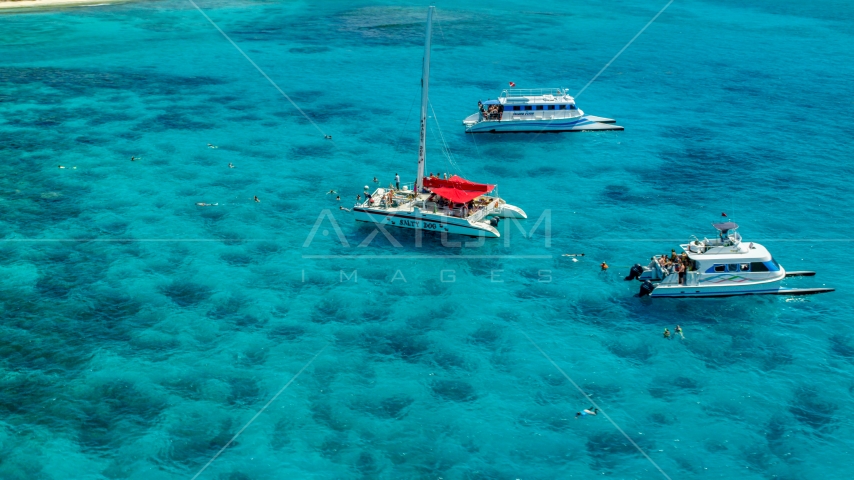Three catamarans in clear blue water, Rada Fajardo, Puerto Rico Aerial Stock Photo AX102_079.0000055F | Axiom Images