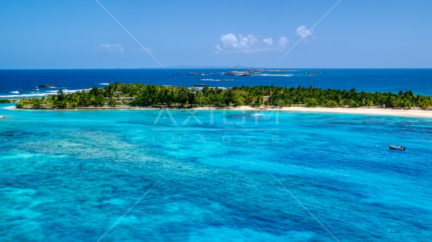 High above tropical blue waters near a small island, Puerto Rico Aerial Stock Photo AX102_083.0000278F | Axiom Images