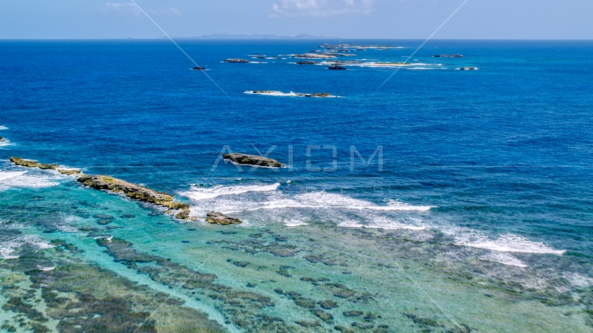 Rocks and waves in tropical blue waters, Puerto Rico Aerial Stock Photo AX102_084.0000239F | Axiom Images