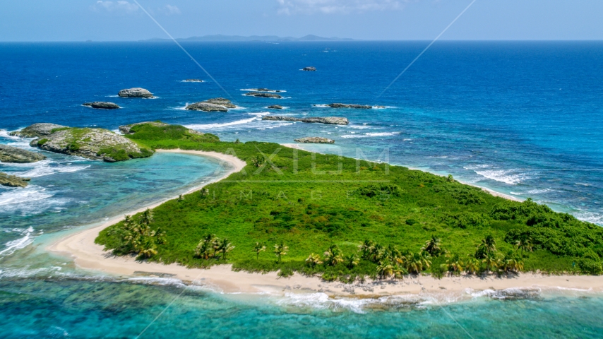Tiny green island with beach in sapphire blue water, Puerto Rico Aerial Stock Photo AX102_089.0000033F | Axiom Images