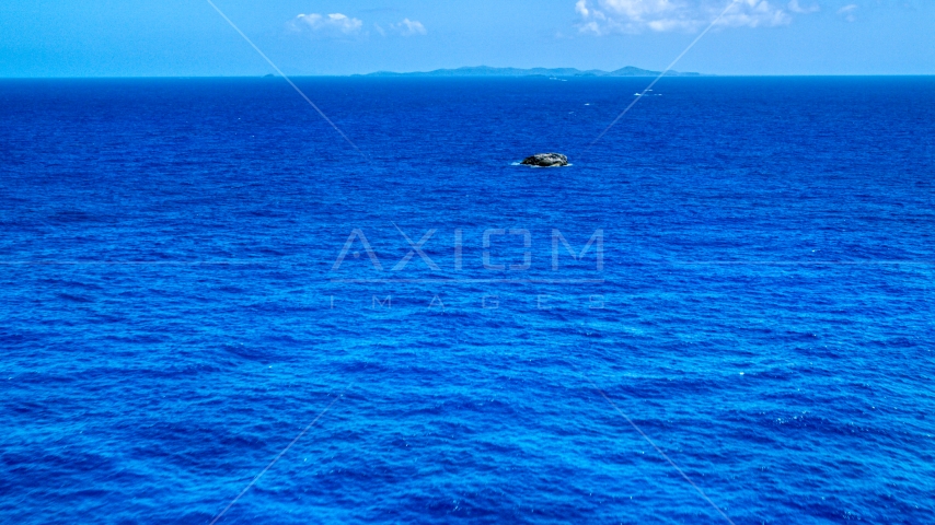 Tiny rocky island in sapphire blue ocean, Puerto Rico Aerial Stock Photo AX102_090.0000165F | Axiom Images