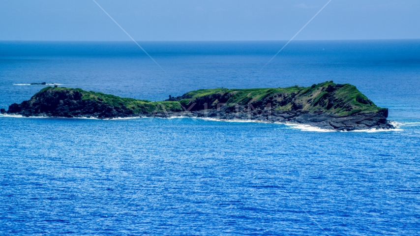 Small rocky green island in sapphire blue waters, Culebra, Puerto Rico Aerial Stock Photo AX102_104.0000000F | Axiom Images