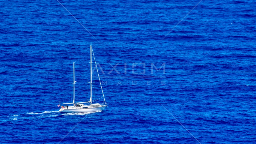 Sail boat in sapphire blue waters, Culebra, Puerto Rico Aerial Stock Photo AX102_105.0000100F | Axiom Images