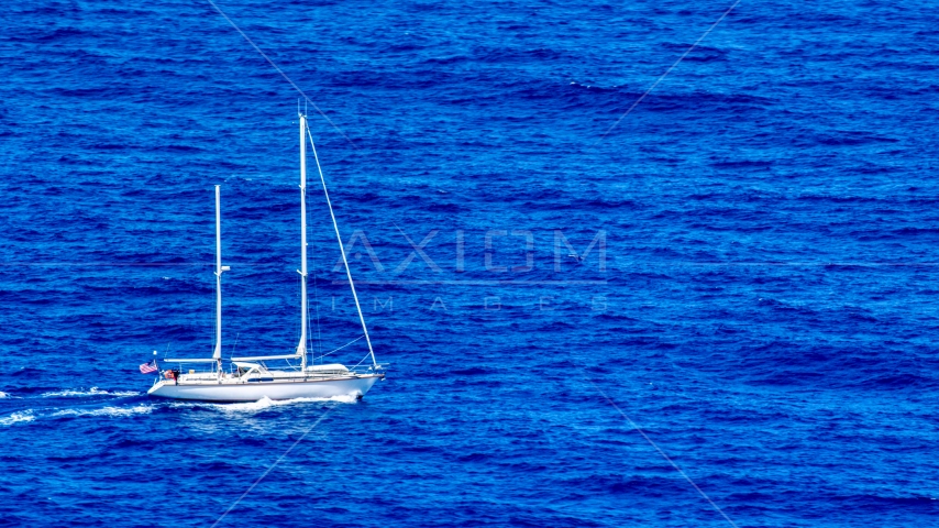 Sail boat in sapphire blue waters, Culebra, Puerto Rico Aerial Stock Photo AX102_106.0000000F | Axiom Images