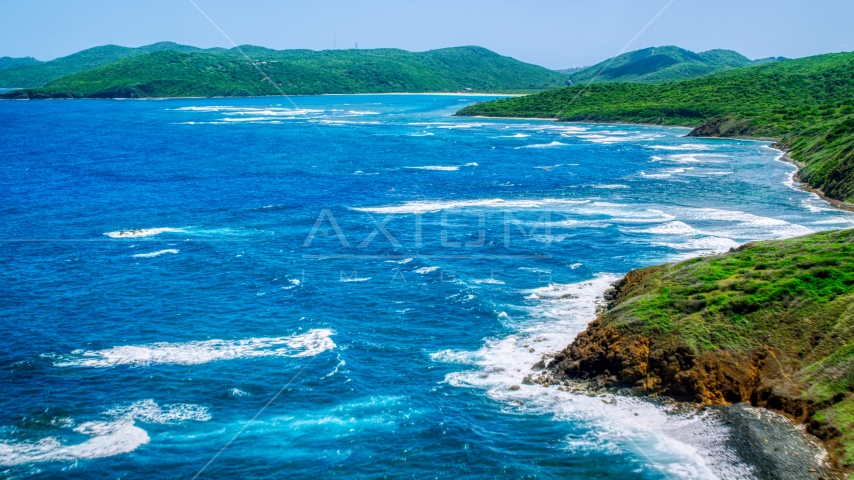 Sapphire blue waters by a green island coastline, Culebra, Puerto Rico Aerial Stock Photo AX102_109.0000094F | Axiom Images