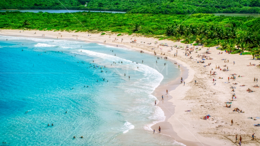Sunbathers on a white sand Caribbean beach in Culebra, Puerto Rico Aerial Stock Photo AX102_112.0000187F | Axiom Images