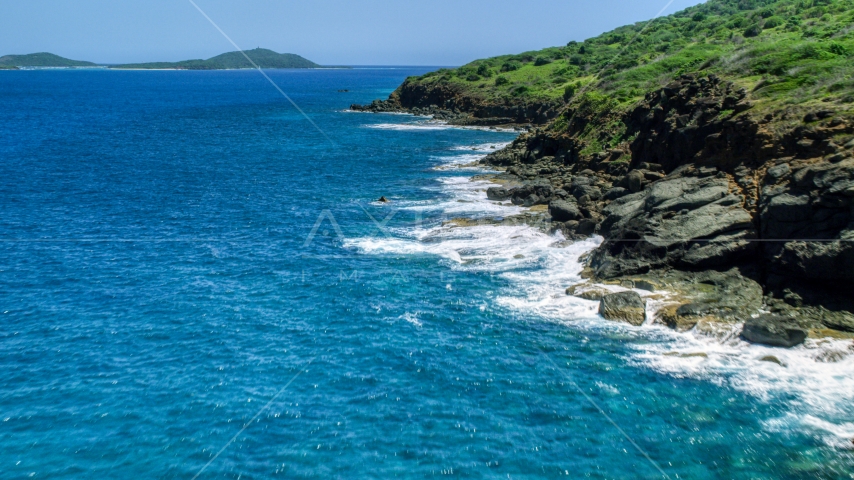 Sapphire blue waters and a rugged island coast, Culebra, Puerto Rico Aerial Stock Photo AX102_128.0000116F | Axiom Images