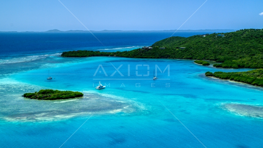 Fishing boat and sailboats in turquoise blue waters along the island coast, Culebra, Puerto Rico Aerial Stock Photo AX102_136.0000000F | Axiom Images