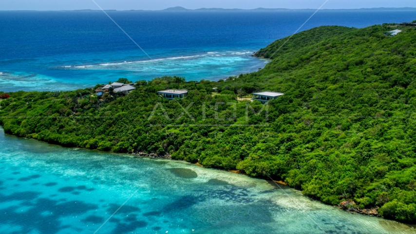 Oceanfront homes and trees overlooking sapphire blue waters, Culebra, Puerto Rico Aerial Stock Photo AX102_137.0000000F | Axiom Images