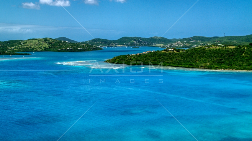 Hilltop homes overlooking sapphire blue waters near a coastal town, Culebra, Puerto Rico Aerial Stock Photo AX102_138.0000238F | Axiom Images