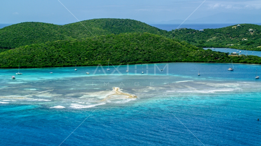 Sailboats in turquoise waters beside a tree covered island coast, Culebra, Puerto Rico Aerial Stock Photo AX102_140.0000000F | Axiom Images