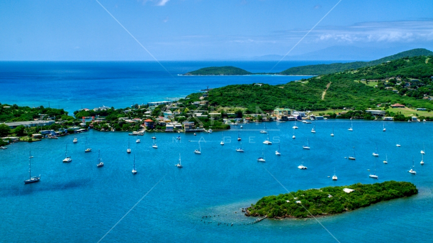 Sailing boats in sapphire blue water near a coastal town, Culebra, Puerto Rico Aerial Stock Photo AX102_142.0000195F | Axiom Images