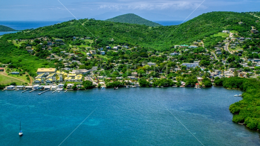 Coastal town with small factory beside blue waters, Culebra, Puerto Rico Aerial Stock Photo AX102_143.0000190F | Axiom Images