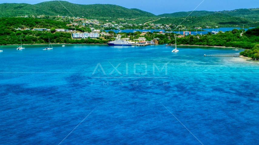 Ferry in the sapphire blue bay by a coastal town, Culebra, Puerto Rico Aerial Stock Photo AX102_148.0000000F | Axiom Images