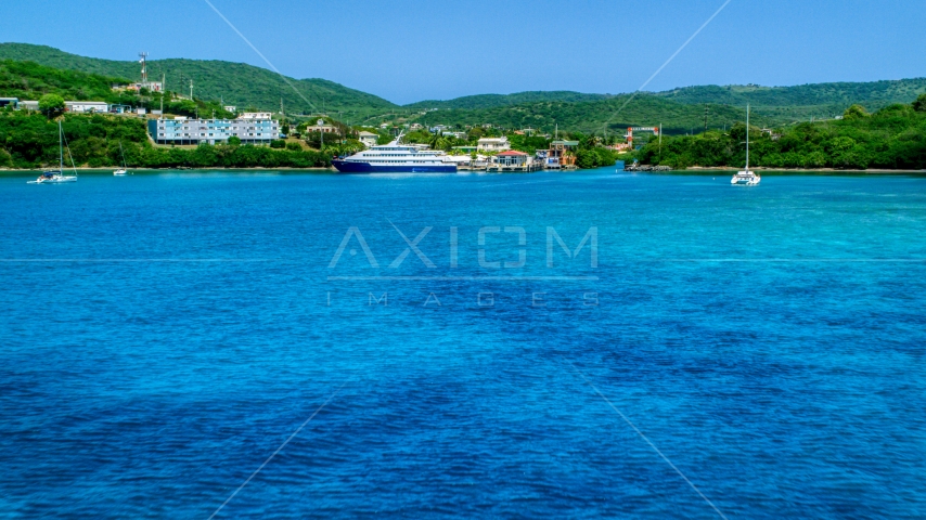 Ferry across a sapphire blue bay in Culebra, Puerto Rico Aerial Stock Photo AX102_148.0000239F | Axiom Images