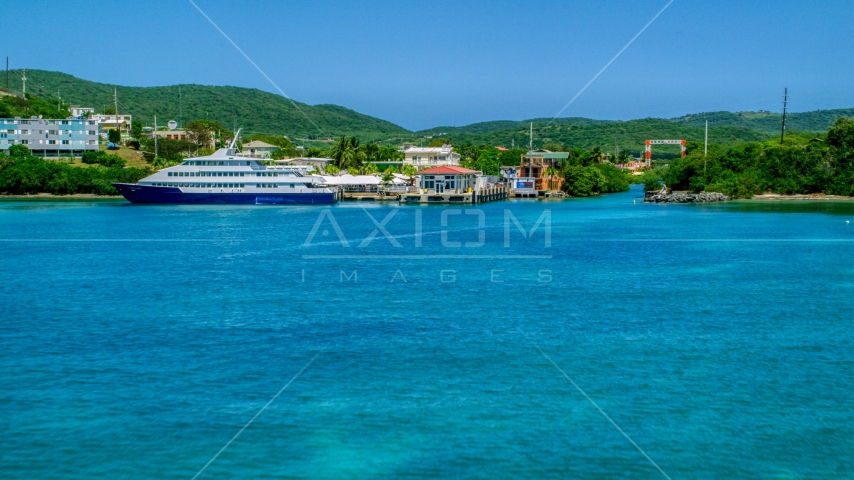 Docked ferry in sapphire blue bay by the coast, Culebra, Puerto Rico Aerial Stock Photo AX102_149.0000236F | Axiom Images