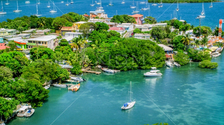 Boats docked at an island town on sapphire water, Culebra, Puerto Rico Aerial Stock Photo AX102_151.0000138F | Axiom Images