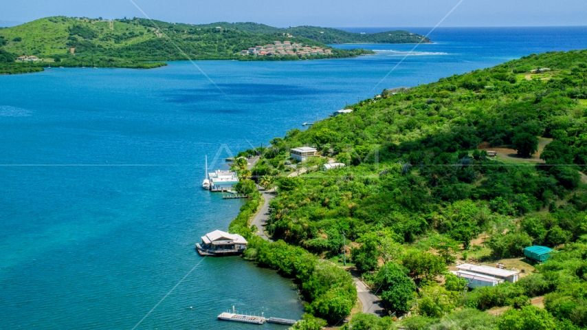 Oceanfront homes along the coast by sapphire waters, Culebra, Puerto Rico Aerial Stock Photo AX102_153.0000125F | Axiom Images