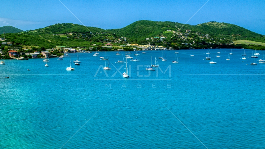 Sailboats in sapphire blue harbor near the coastal island town on Culebra, Puerto Rico Aerial Stock Photo AX102_161.0000000F | Axiom Images