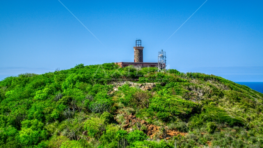 The Culebrita Lighthouse on a Caribbean island hilltop, Puerto Rico Aerial Stock Photo AX102_178.0000000F | Axiom Images