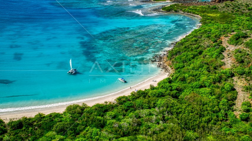 Pair of boats beside a white sand beach on the Caribbean island of Culebrita, Puerto Rico Aerial Stock Photo AX102_180.0000255F | Axiom Images